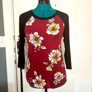 Lovely floral shirt with soft black sleeves that have slight stretch.